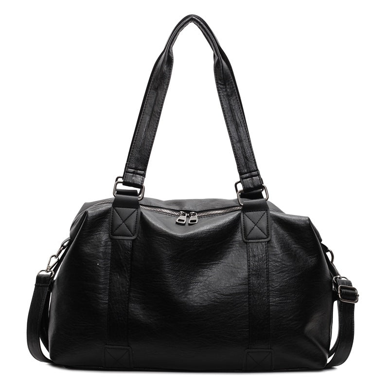 Black PU weekender bag with two carry handles, a zip top and shoulder strap on a white background.
